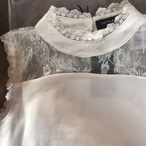 White knee length dress with beautiful lace work.